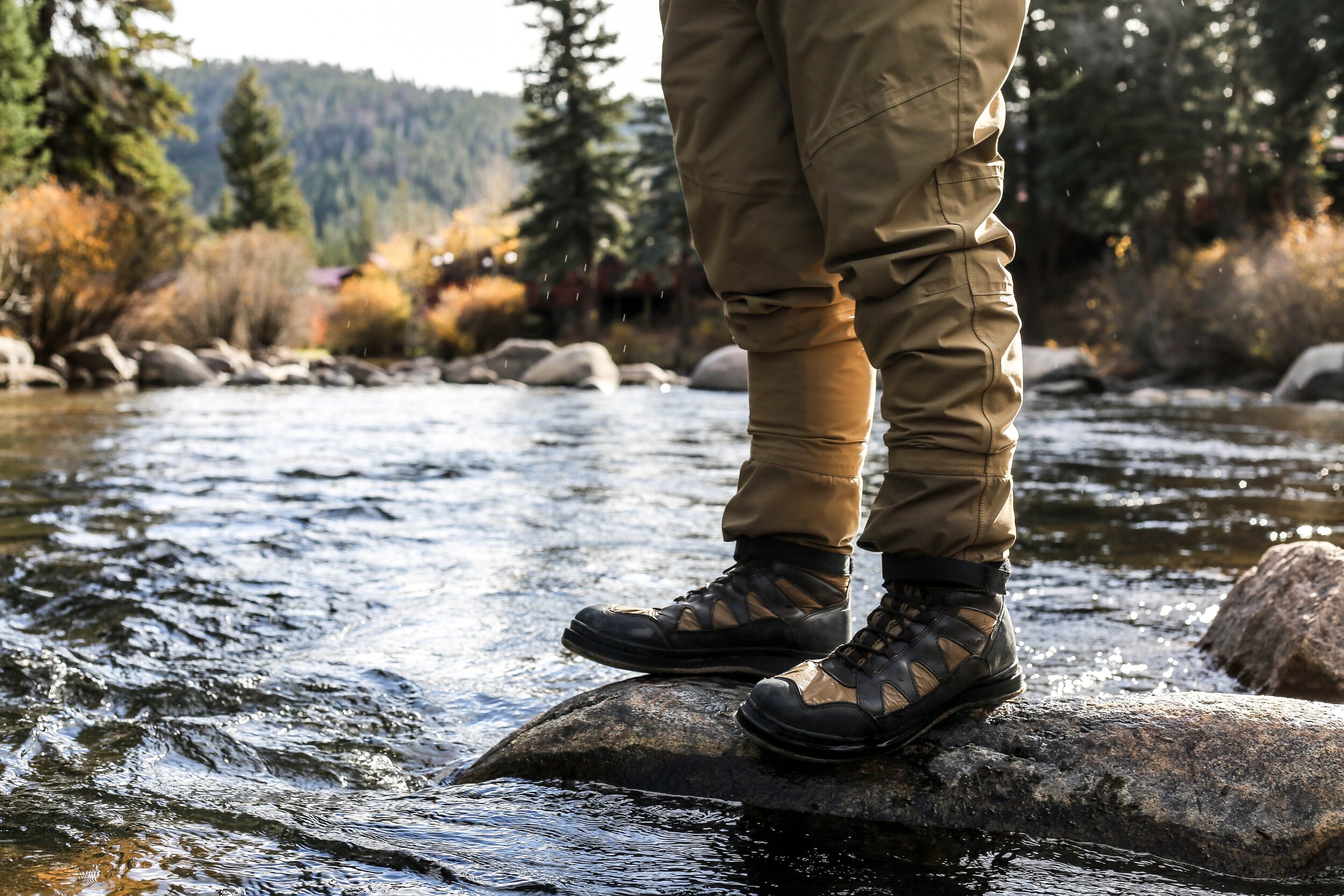 fisherman standing next to water